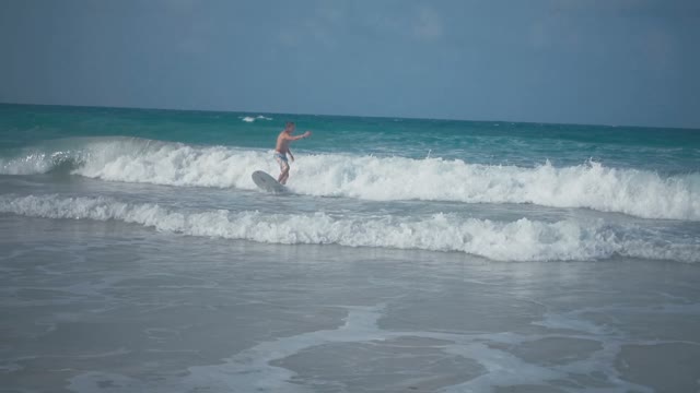 Young Attractive Surfer Riding On A Blackboard