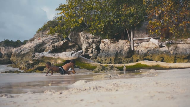 Small Black Children Playing On The Beach