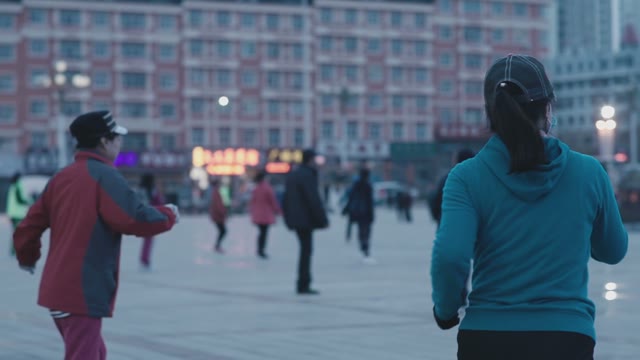 Asian Women Simultaneously Dancing In The Street