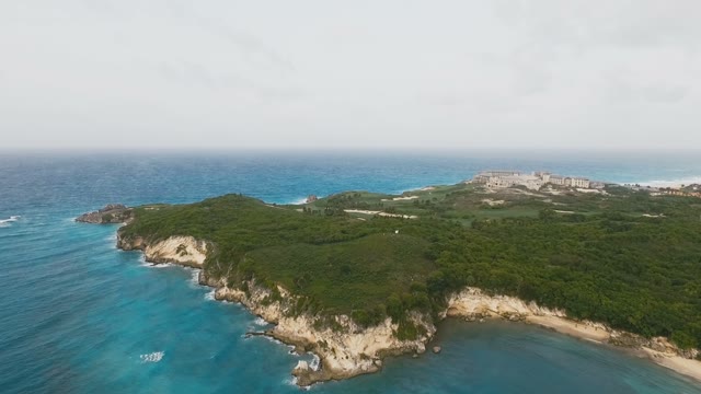 Beautiful Blue Sea Rocky Terrain Covered With Grass And Magnificent Grassy Hills