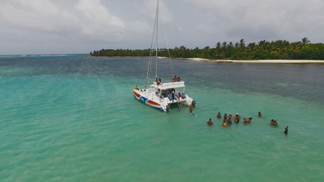 People Throw Things On A Yacht And Rest Around Her