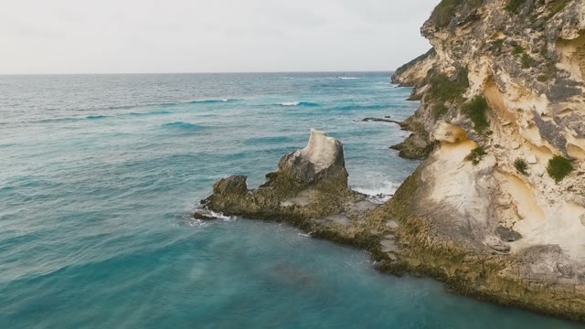Quiet, Mesmerizing Rocky Terrain Covered With Grass And Blue Sea