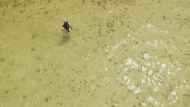 Black Man Catches Fish In The River