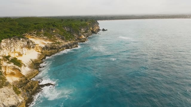 Beautiful Rocks Overgrown With Grass And Mesmerizing Blue Sea