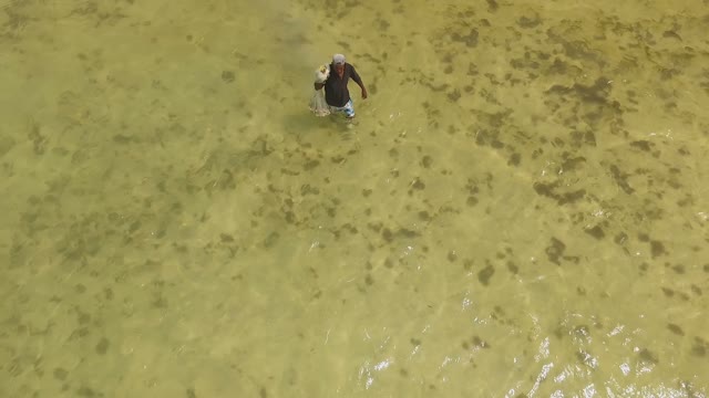 The Man Goes Fishing With A Net
