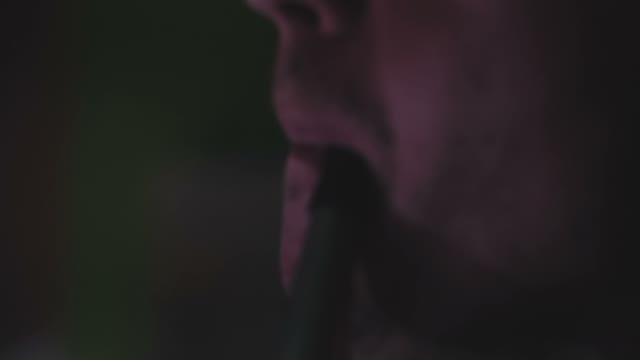 Man Exhales Smoke From A Hookah Close-up