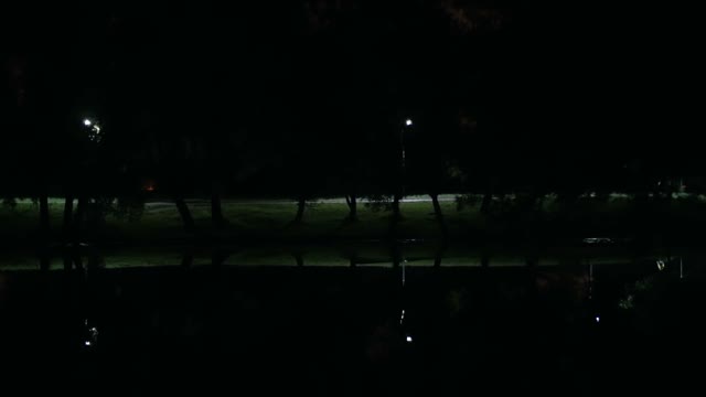 Cyclist Riding At Night Park Close-up
