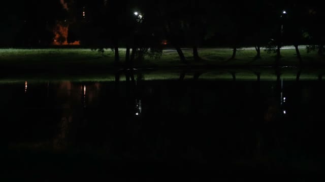 Cyclist Riding At Night Park Close-up