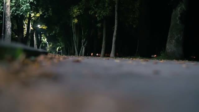 Cyclist Rides Along A Road At Night Close-up