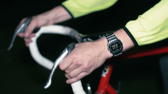 Cyclist Riding A Bicycle At Night Close-up