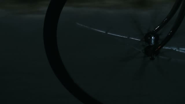 Cyclist Riding A Bicycle At Night Close-up