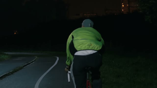 Cyclist Riding A Bicycle At Night Close-up