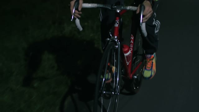 Cyclist Riding A Bicycle At Night Close-up