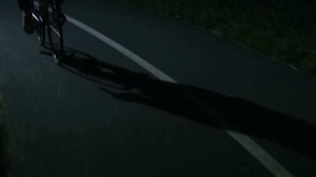 Cyclist Riding A Bicycle At Night Close-up