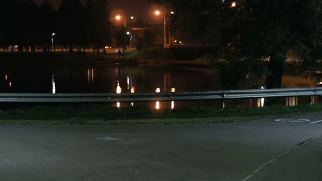 Cyclist Riding A Bicycle At Night Close-up