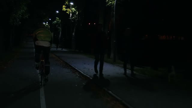 Cyclist Riding A Bicycle At Night Close-up