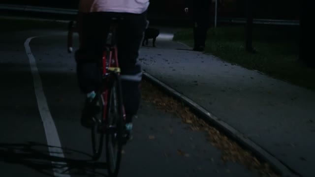 Cyclist Riding A Bicycle At Night Close-up