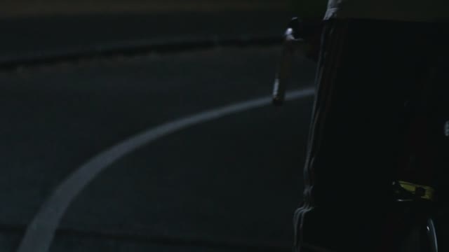 Cyclist Riding A Bicycle At Night Close-up