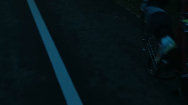 Cyclist Riding A Bicycle At Night Close-up