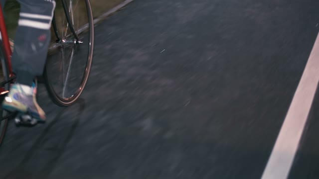 Cyclist Riding A Bicycle At Night Close-up