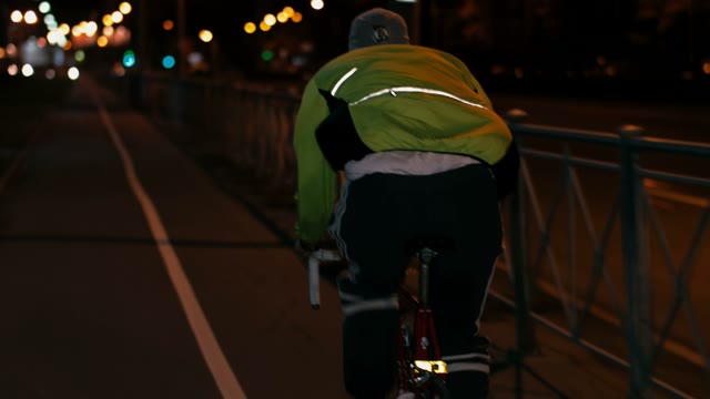 Cyclist Riding A Bicycle At Night Close-up