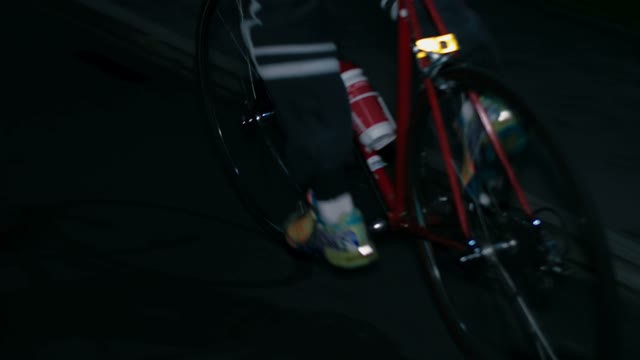 Cyclist Riding A Bicycle At Night Close-up