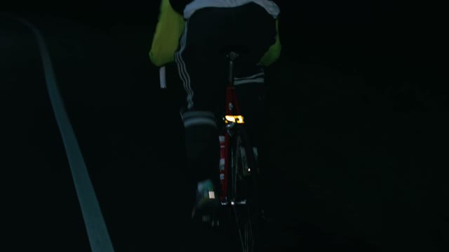 Cyclist Riding At Night Close-up