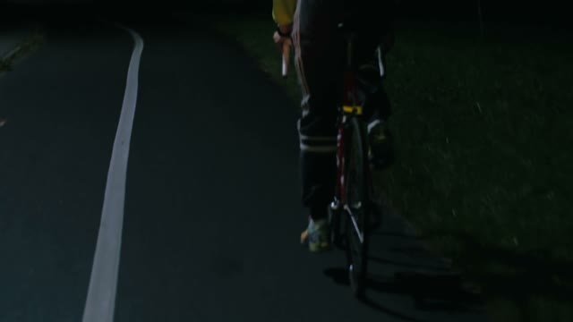 Cyclist Riding At Night Close-up