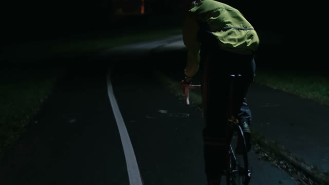 Cyclist Riding At Night Close-up