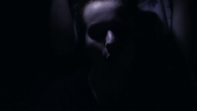 Girl Makes Faces In The Dark Close-up