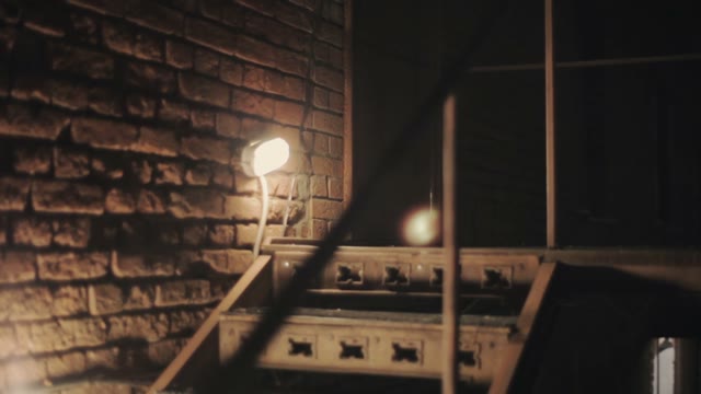 Glowing Lamp On A Brick Wall Close-up