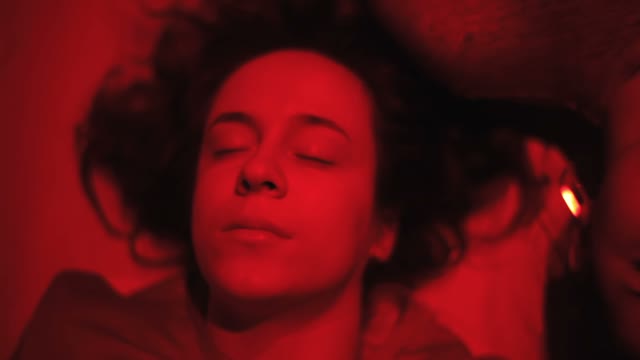 Faces Of A Girls In Red Light Close-up