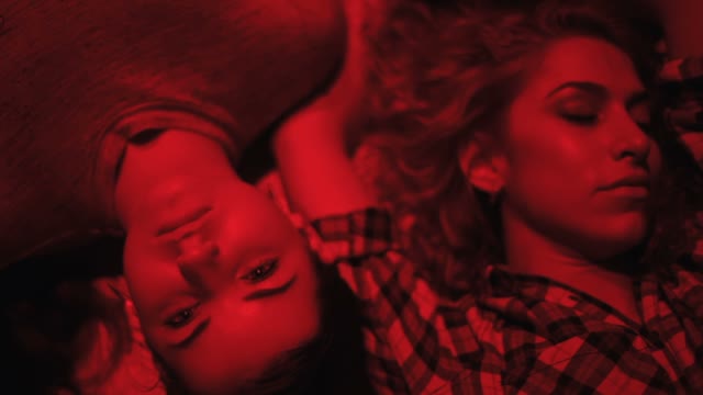 Faces Of A Girls In Red Light Close-up