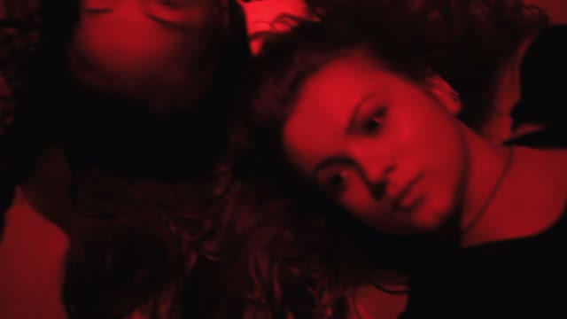 Faces Of A Girls In Red Light Close-up