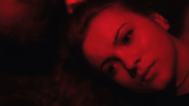 Faces Of A Girls In Red Light Close-up