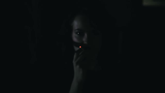 Girl Smokes In The Dark Close-up