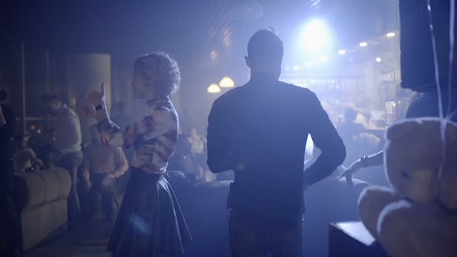 Man With A Saxophone Applauds On Stage Close-up
