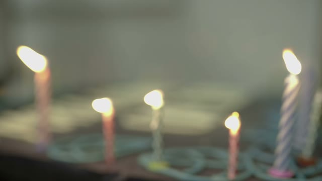 Hand Ignites The Candles On The Cake Close-up