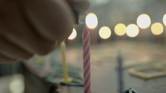 Hand Ignites The Candles On The Cake Close-up