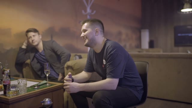 Company Of Friends Communicate And Smoke A Hookah