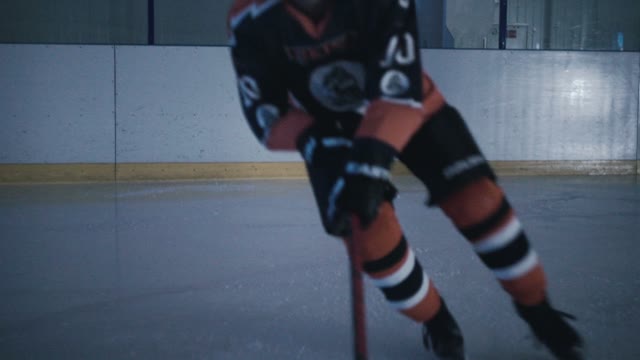 Hockey Player Hits The Puck With A Stick Close-up