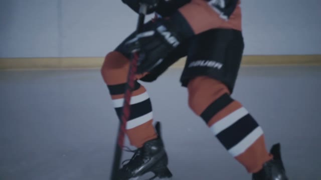 Hockey Player Hits The Puck With A Stick Close-up