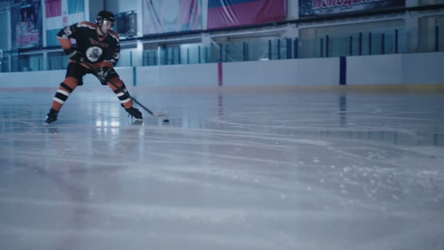 Hockey Player Tries To Score The Puck Into The Goal