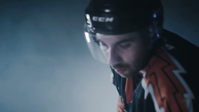Hockey Player Hits The Puck With A Stick Close-up