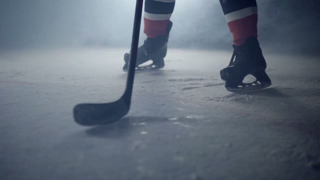 Hockey Player Hits The Puck With A Stick Close-up
