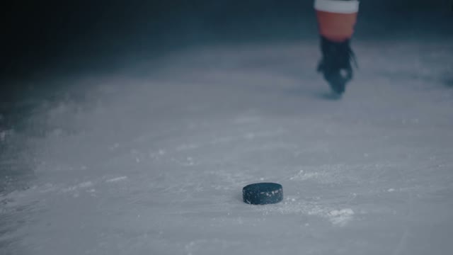 Hockey Player Hits The Puck With A Stick Close-up