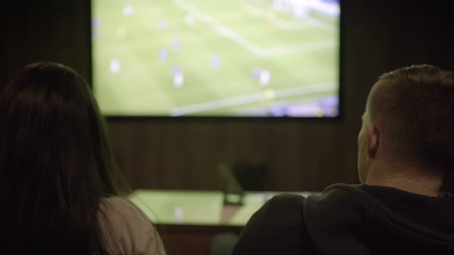 Man And Woman Watching Football Close-up