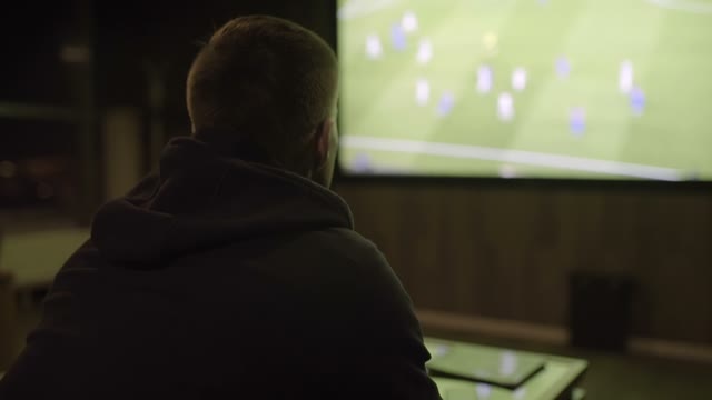 Young Man Watching Football Close-up