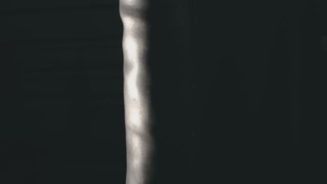 A Woman Beats A Punching Bag In The Gym
