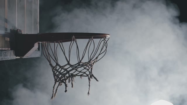 Basketball Player Throws The Ball Into The Ring